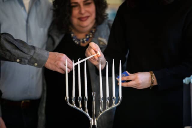 lighting chanukah candles