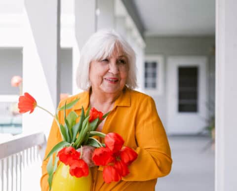 senior woman holding flowers